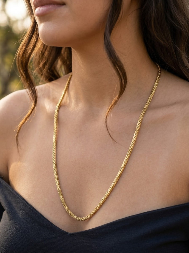 "A sleek and intricately woven gold chain 50 gm
