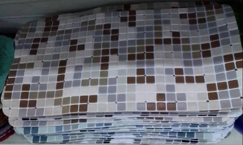 Stack of patterned fabric on a shelf with a tiled floor in the foreground