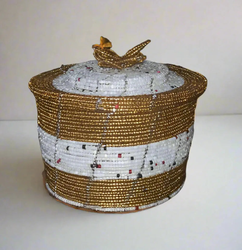 Hand holding a beaded container with a blurred background