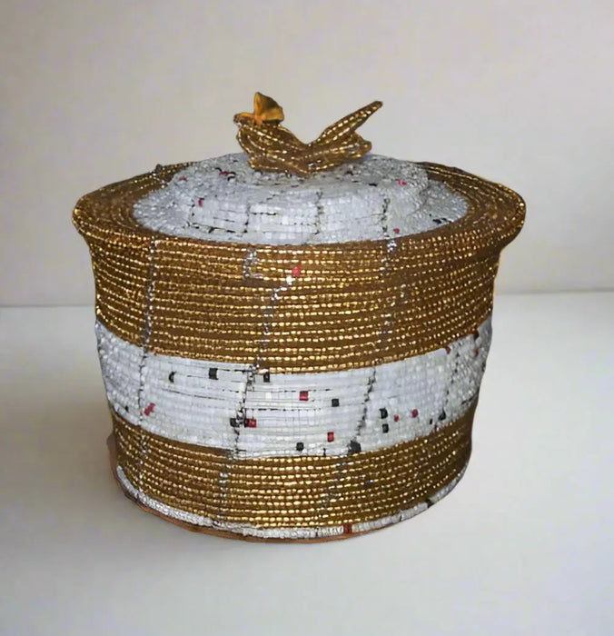 Hand holding a beaded container with a blurred background