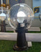 Cone-shaped outdoor lamp post with a clear glass sphere globe. Murukali.com