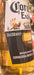Hand holding a bottle of Corona Extra beer in a store setting