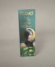 Cosmo Amla Hair Oil packaging held by a person in a store setting