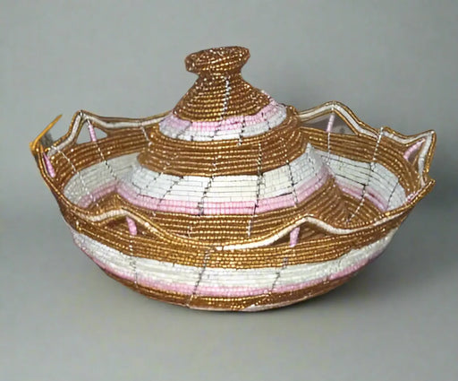 Hand holding a woven boat model with shelves displaying various woven items in the background.