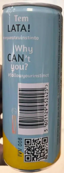 Can held by a hand with a barcode and text on a grocery store floor.