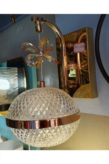 Gold-colored wall-mounted light fixture Murukali.com