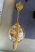 Gold-colored wall-mounted light fixture Murukali.com
