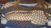 Woman wearing a striped shirt with a gold lace collar in a store setting