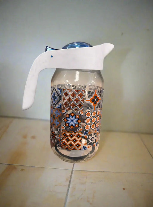 Decorative glass container with a white spray nozzle held by a person in a store.