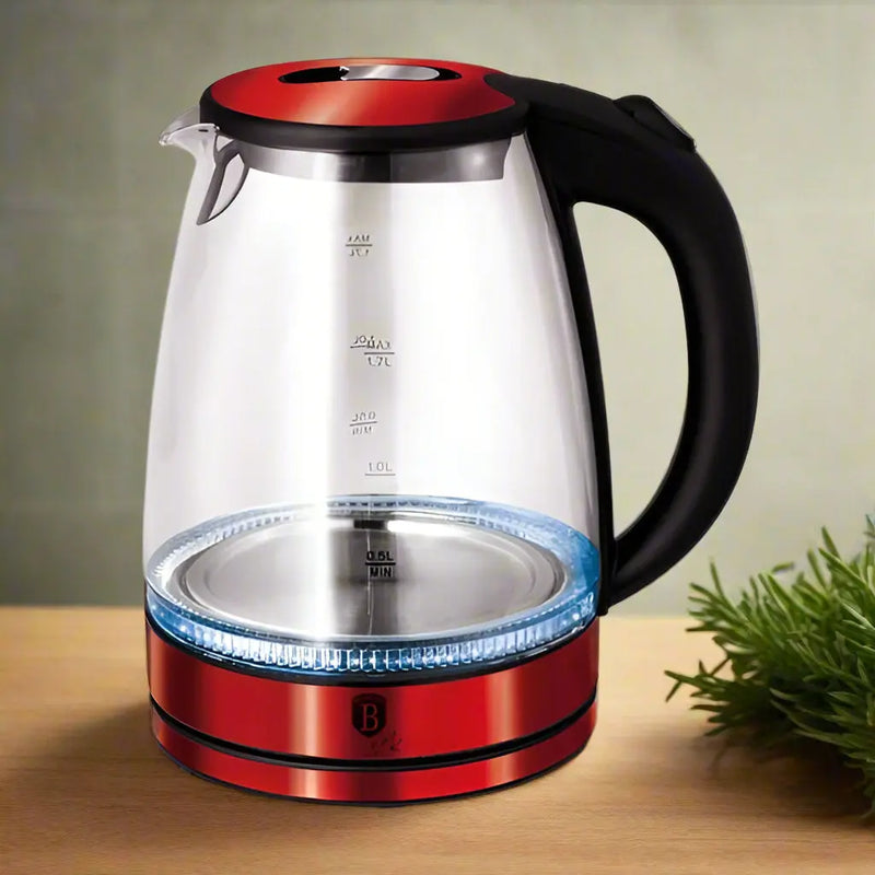 Clear electric kettle with red base and black handle on a white background