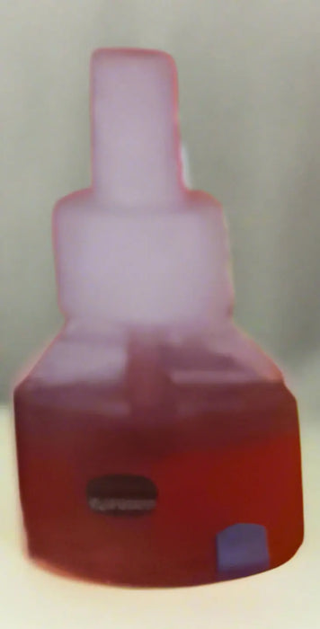 Hand holding a red and yellow box of 'garper' liquid mosquito killer in a store aisle.