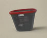 Black laundry basket with a red rim on a tiled floor