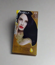 Orabella hair color cream package held by a hand on a tiled floor.