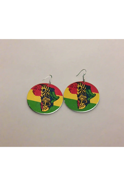 Colorful earrings with a design on a green surface