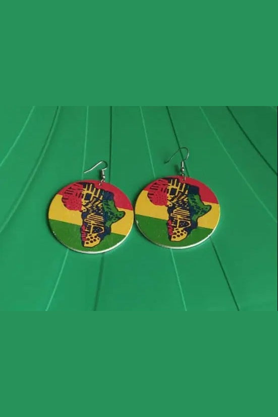 Colorful earrings with a design on a green surface