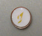 Round object with a white center and gold border held by a hand
