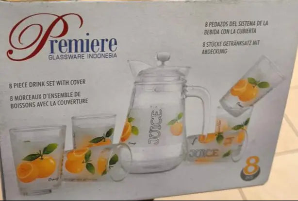 Box of Premiere glassware set held by a person in a store.