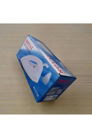 Hand holding a box of a Royal Deluxe iron on a tiled floor.
