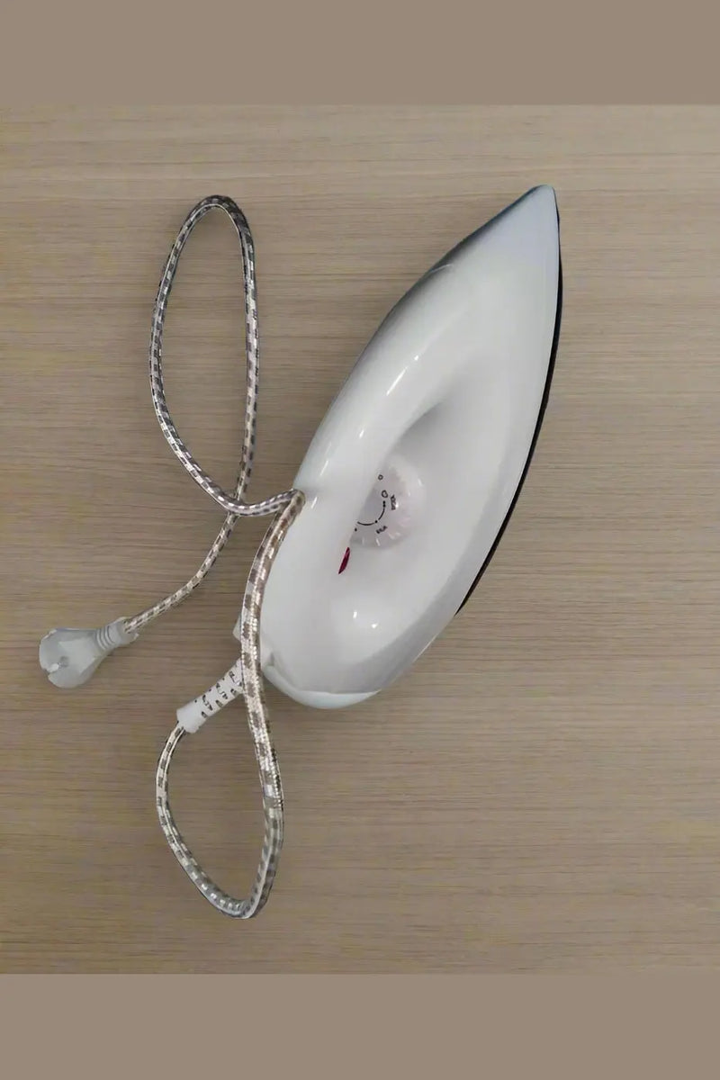 White iron on a shelf with boxes in the background