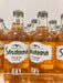 Bottles of Savanna Premium Cider with visible labels on a reflective surface.