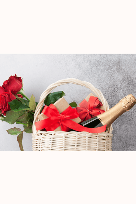 Gift basket with Wrapped Crackers, a bottle of champagne, and bunch of roses