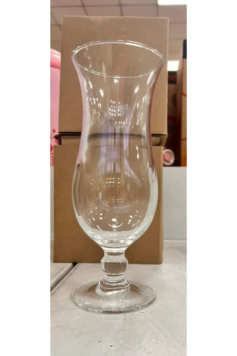 Clear glass with a stem on a store shelf with boxes in the background
