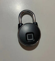 Black electronic lock with a square sensor on a light gray background
