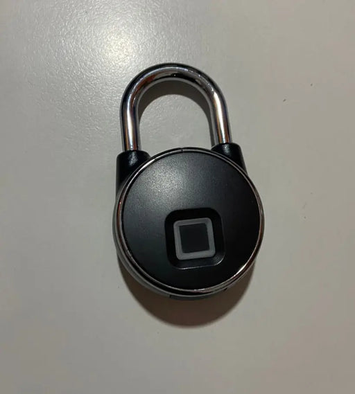 Black electronic lock with a square sensor on a light gray background