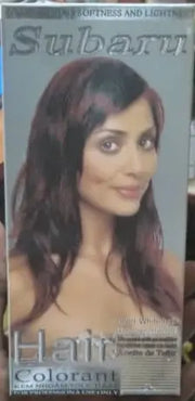 Hand holding a box of Subbani Hair Colorant in a store setting