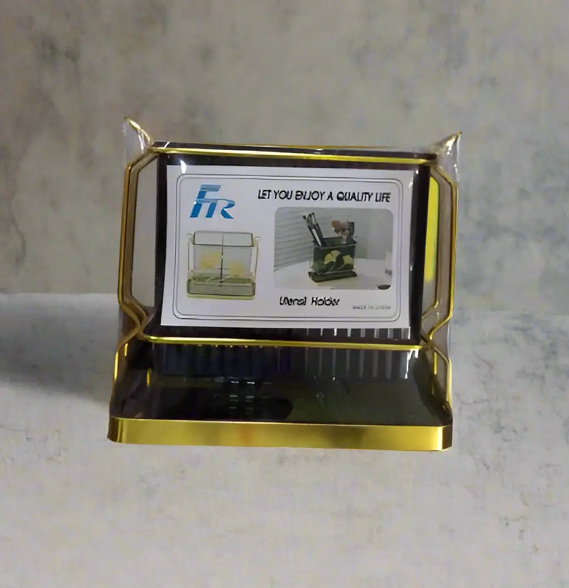 Gold-framed product display held by a hand in a store setting