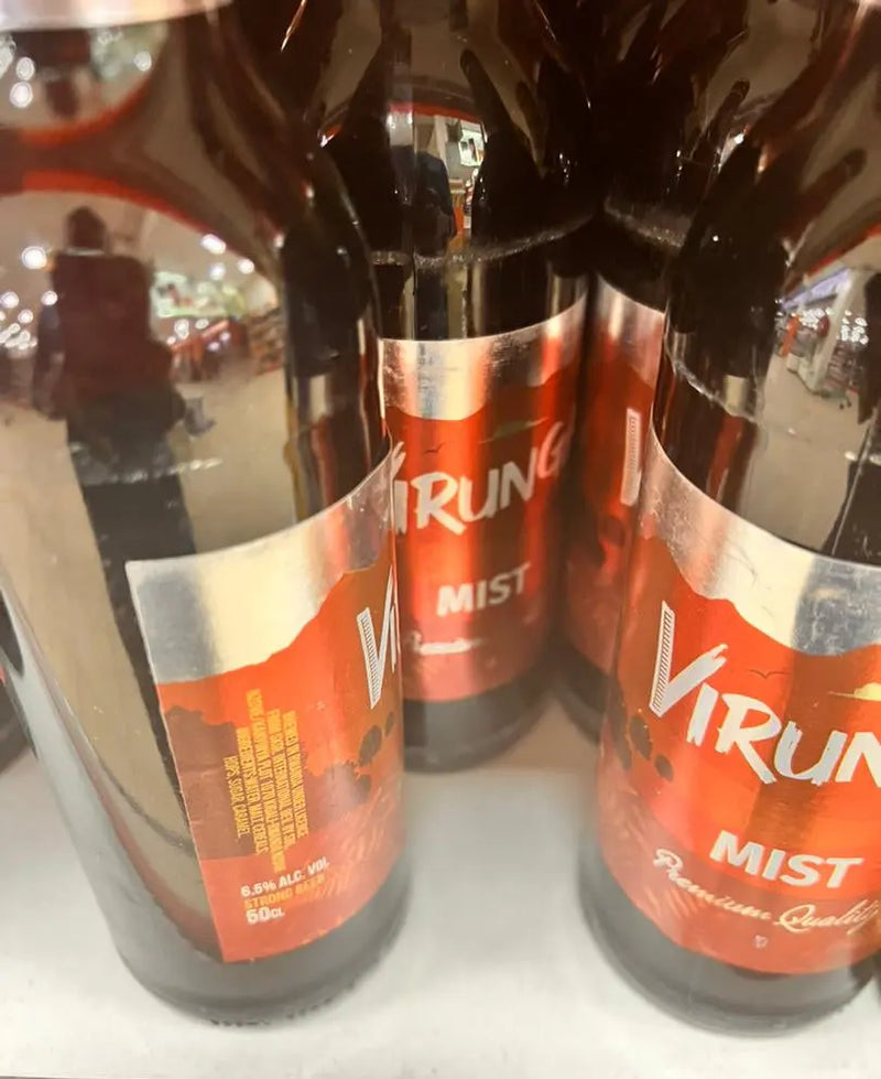 Three bottles of Virun Mist on a reflective surface with a blurred background.