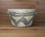 Handheld woven basket with a checkered pattern in a casual setting
