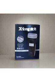 X-long electric shaver box held by a hand on a tiled floor.