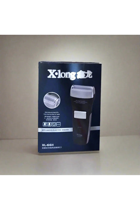 X-long electric shaver box held by a hand on a tiled floor.