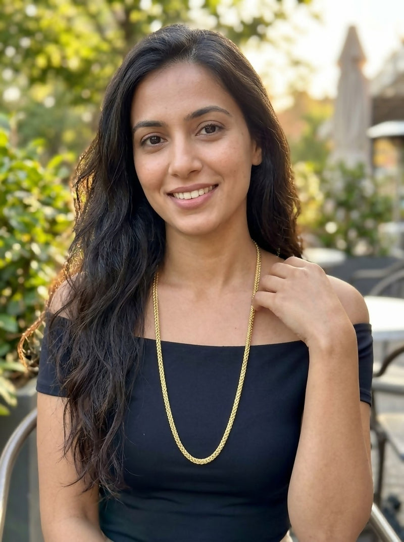 "A sleek and intricately woven gold chain 50 gm